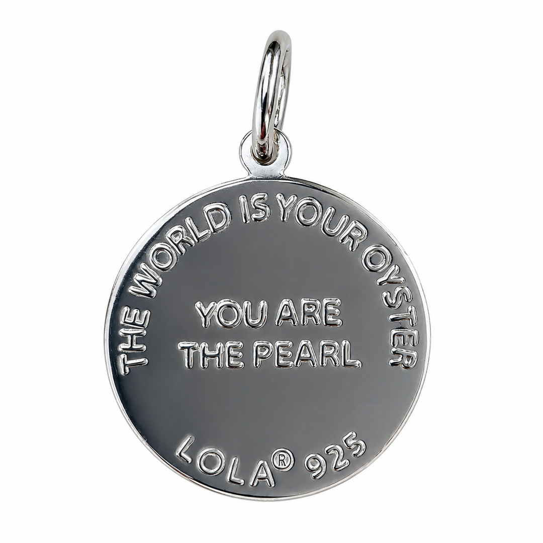 A silver oval pendant charm featuring the engraved quote &